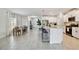 Open-concept kitchen with white cabinets, stainless steel appliances, and seamless flow into the dining and living areas at 22287 Storybook Cabin Way, Land O Lakes, FL 34637