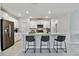 Bright, open kitchen boasts white cabinets, stainless appliances, and a spacious island with seating for three at 22287 Storybook Cabin Way, Land O Lakes, FL 34637