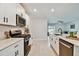 Contemporary kitchen featuring white cabinets, quartz countertops, and stainless steel appliances at 22287 Storybook Cabin Way, Land O Lakes, FL 34637