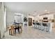 Open-concept design seamlessly connects dining, hallway, and kitchen areas, enhancing the home's spacious feel at 22287 Storybook Cabin Way, Land O Lakes, FL 34637