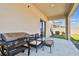Outdoor patio space with grill, seating, and adjacent grassy yard at 22287 Storybook Cabin Way, Land O Lakes, FL 34637
