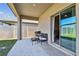 Covered patio seating area featuring a grill and sliding glass doors at 22287 Storybook Cabin Way, Land O Lakes, FL 34637