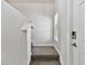 Stairway to second level with neutral walls, carpeted steps, a window with blinds and an electronic door lock at 22287 Storybook Cabin Way, Land O Lakes, FL 34637
