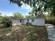 A spacious backyard and patio area is surrounded by mature trees at 2315 Carroll Pl, Tampa, FL 33612
