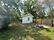 The home's backyard features a fire pit, shed, and privacy fence at 2315 Carroll Pl, Tampa, FL 33612