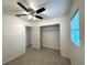 This spacious bedroom has a ceiling fan, closet, window, and tile floors at 2315 Carroll Pl, Tampa, FL 33612