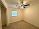 Bedroom features a ceiling fan, tiled floor and window for plenty of natural light at 2315 Carroll Pl, Tampa, FL 33612