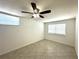 Bedroom with tiled floor, ceiling fan, and natural light from two windows with blinds at 2315 Carroll Pl, Tampa, FL 33612