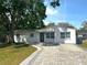 Charming one-story home with brick-paved driveway and lush green lawn at 2315 Carroll Pl, Tampa, FL 33612