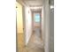 Hallway with tile flooring leading to bedrooms with neutral paint and natural lighting at 2315 Carroll Pl, Tampa, FL 33612