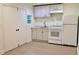 Bright kitchen features white cabinets, modern appliances, and light-colored flooring for a clean, updated look at 2315 Carroll Pl, Tampa, FL 33612