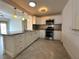 Beautiful kitchen features white cabinets, stainless steel appliances, and tile flooring at 2315 Carroll Pl, Tampa, FL 33612
