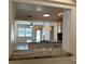Kitchen pass-through view with granite counters, stainless appliances and pendant lights at 2315 Carroll Pl, Tampa, FL 33612