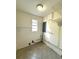 Laundry room featuring tile floors, window, and utility connections at 2315 Carroll Pl, Tampa, FL 33612