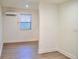 Bright living room with light wood floors, fresh white paint, and a mini-split air conditioning unit at 2315 Carroll Pl, Tampa, FL 33612