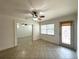 Bright living room with tile flooring, ceiling fan, and natural light at 2315 Carroll Pl, Tampa, FL 33612