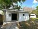 A quaint outbuilding with a covered porch adds charm to the well-maintained backyard at 2315 Carroll Pl, Tampa, FL 33612