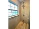 Tiled walk-in shower with shower head, decorative tile and window at 2315 Carroll Pl, Tampa, FL 33612