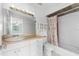 Bathroom with vanity and drawers, shower and tub with nautical themed shower curtain at 2418 N Links Ave, Sarasota, FL 34234