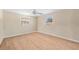 Sun-lit bedroom with wood flooring, and two windows providing plenty of light at 2418 N Links Ave, Sarasota, FL 34234