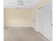 Bedroom with ceiling fan, double closets, and neutral carpet, ready for personalization at 2418 N Links Ave, Sarasota, FL 34234