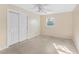 Bedroom with a ceiling fan, double door closet, and a window providing natural light at 2418 N Links Ave, Sarasota, FL 34234