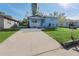 View of light blue home with a concrete driveway at 2418 N Links Ave, Sarasota, FL 34234
