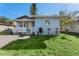 This light blue home offers a cozy front porch and landscaped front yard at 2418 N Links Ave, Sarasota, FL 34234
