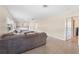 Open-concept living room with view to kitchen, terrazzo floors, and a neutral color palette at 2418 N Links Ave, Sarasota, FL 34234