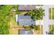 Aerial view of fenced backyard, driveway, landscaping and mature trees at 29013 Old Marsh End, Wesley Chapel, FL 33543