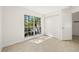 Sunny bedroom with wood-look floors, closet and natural light filtering through the window at 29013 Old Marsh End, Wesley Chapel, FL 33543