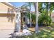 Close up of the front of the home with walkway, landscaping and tan exterior at 29013 Old Marsh End, Wesley Chapel, FL 33543