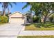 Inviting home with lush landscaping, mature trees, and a well-maintained lawn at 29013 Old Marsh End, Wesley Chapel, FL 33543