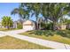 Landscaped front yard with beautiful trees shading the charming single-Gathering home at 29013 Old Marsh End, Wesley Chapel, FL 33543