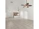 Open-concept living room with tiled floors, adjacent kitchen with modern finishes, and bright, natural light at 29013 Old Marsh End, Wesley Chapel, FL 33543