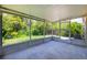 Large screened porch with views of the backyard and mature trees at 29013 Old Marsh End, Wesley Chapel, FL 33543