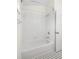 Clean white tiled bathtub with shower, and updated fixtures at 29013 Old Marsh End, Wesley Chapel, FL 33543