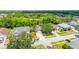 Charming single Gathering home features mature trees, manicured lawn, and a cozy two-car driveway at 29013 Old Marsh End, Wesley Chapel, FL 33543