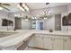 Spacious bathroom featuring a long vanity with double sinks, cabinets, and a large mirror at 2974 Sean Way, Palm Harbor, FL 34684