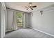 Bright bedroom with a large window, closet, and neutral walls and carpet at 2974 Sean Way, Palm Harbor, FL 34684