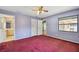 Spacious bedroom features a ceiling fan, closet and attached bath at 2974 Sean Way, Palm Harbor, FL 34684