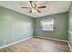 Bedroom featuring laminate floors, a window, and light green walls at 2974 Sean Way, Palm Harbor, FL 34684