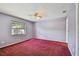 Spacious bedroom with ceiling fan and window overlooking yard at 2974 Sean Way, Palm Harbor, FL 34684