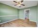 Bedroom boasts wood-look laminate flooring, and the doorway view of the adjacent kitchen at 2974 Sean Way, Palm Harbor, FL 34684