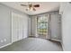Bright bedroom with a large window, closet, and neutral walls and carpet at 2974 Sean Way, Palm Harbor, FL 34684