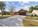 Attractive single-Gathering home featuring a spacious driveway, mature trees, and well-kept landscaping at 2974 Sean Way, Palm Harbor, FL 34684