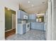 Open kitchen with blue cabinets, modern appliances, and tile floors at 2974 Sean Way, Palm Harbor, FL 34684