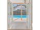 Screened-in pool as seen through the white french doors at 2974 Sean Way, Palm Harbor, FL 34684
