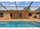 Step into the refreshing pool, accessible from the house through elegant double doors, perfect for hot summer days at 2974 Sean Way, Palm Harbor, FL 34684