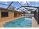 Sparkling in-ground pool enclosed by a screened lanai, offering a private outdoor retreat at 2974 Sean Way, Palm Harbor, FL 34684